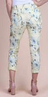 Back view of cropped yellow floral pants with blue and grey flower print, rolled cuffs
