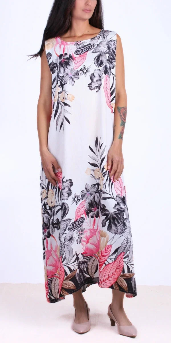 Sleeveless long floral print dress with pink, beige, and black pattern, worn with heels