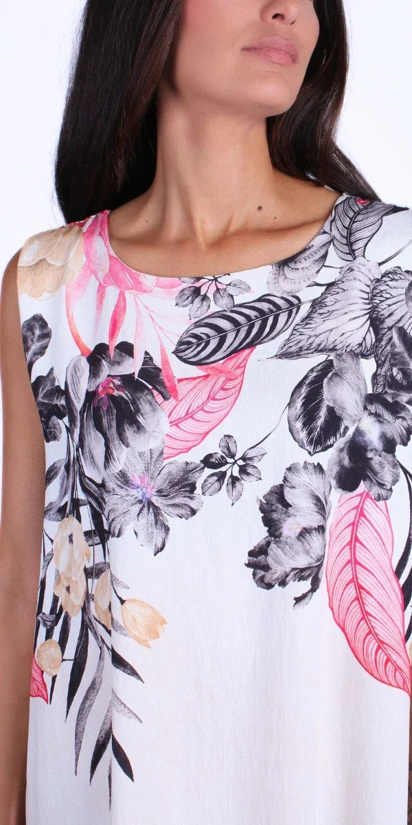 Sleeveless white linen dress with colorful floral and leaf print, close-up view
