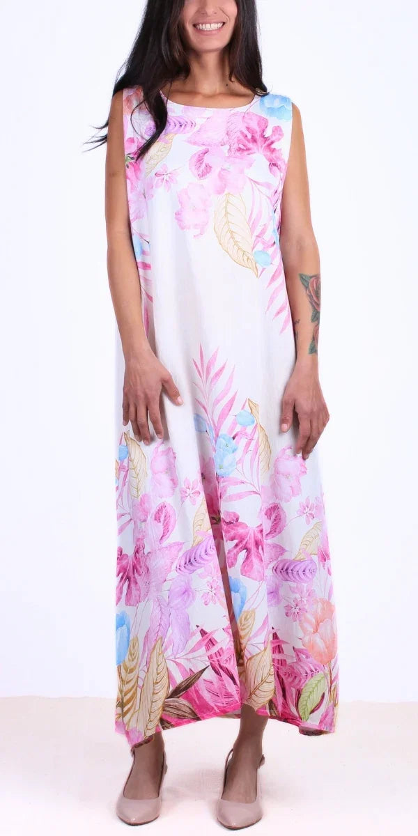 Woman wearing a sleeveless floral maxi dress with pink, blue, and yellow accents