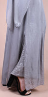 Long silver silk skirt with sequin detail, worn with black high heel sandals