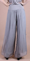 Back view of wide-leg gray silk palazzo pants for women, shown on model