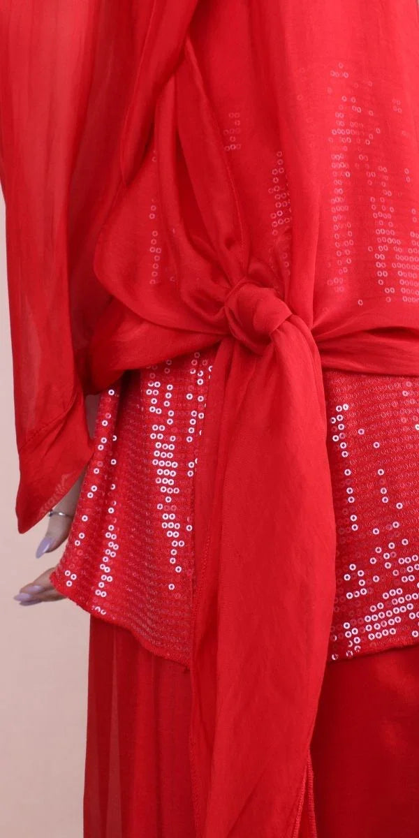 Red sequin blouse with sheer sleeves and a fabric tie waist, elegant women's fashion