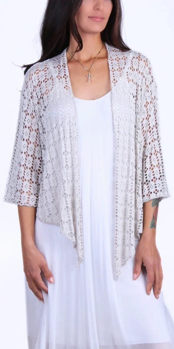 Woman wearing light grey crochet open-front cardigan over a white dress